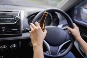 Man consuming alcohol while driving a vehicle in Denver, Colorado