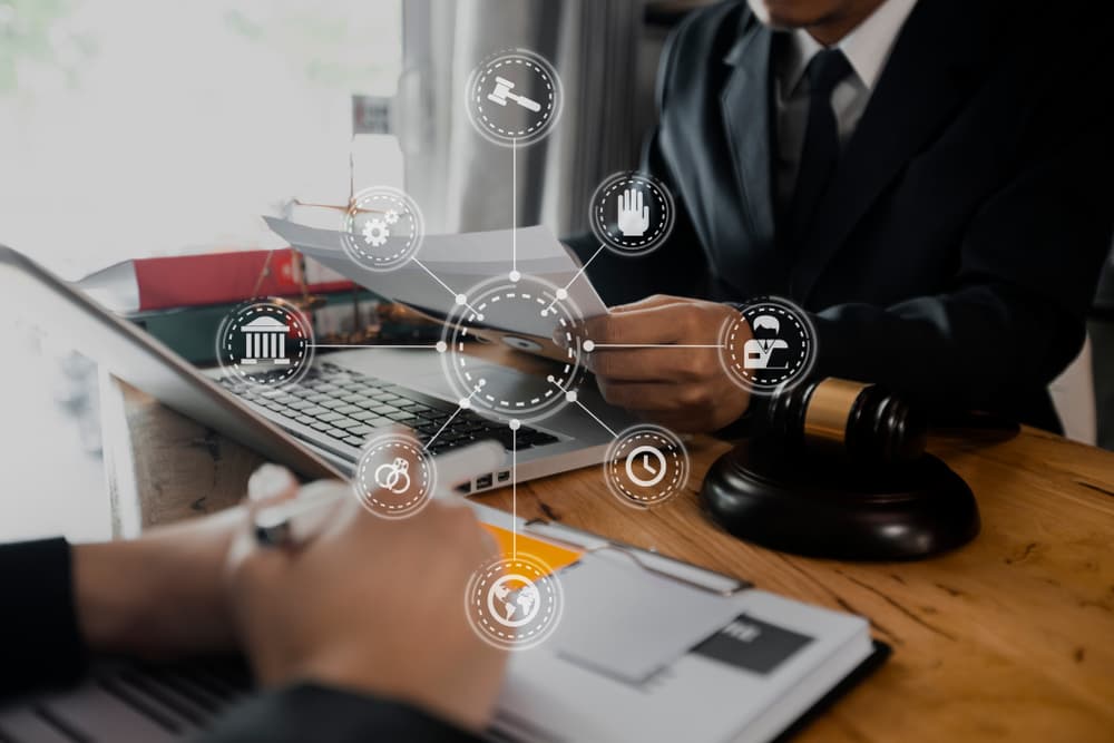 Legal consultation: lawyers meeting client with tablet and laptop, emphasizing good service and cooperation in law and legal services.