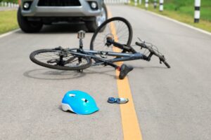 Car crashes with bicycle on road.