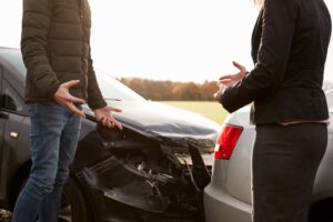 Two drivers arguing over car damage after an accident. 