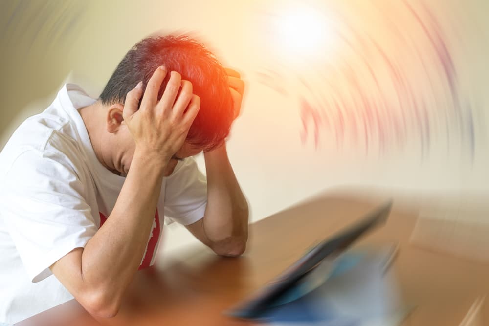 Person suffering delayed concussion symptoms such as dizziness and severe headache