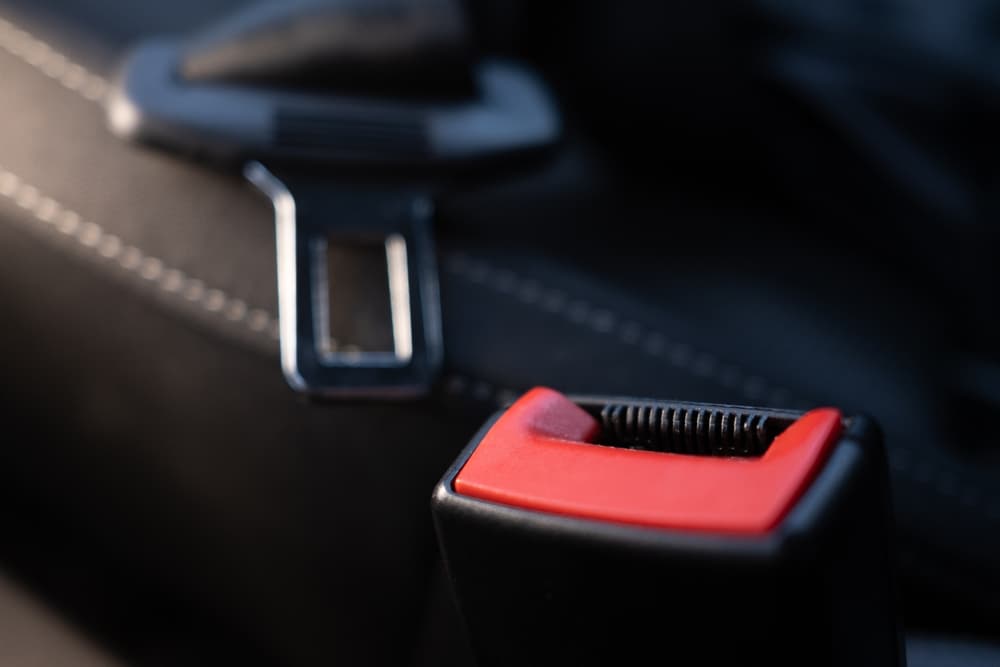 Open car seatbelt buckle highlighting legal questions about suing after not wearing a seatbelt in Colorado