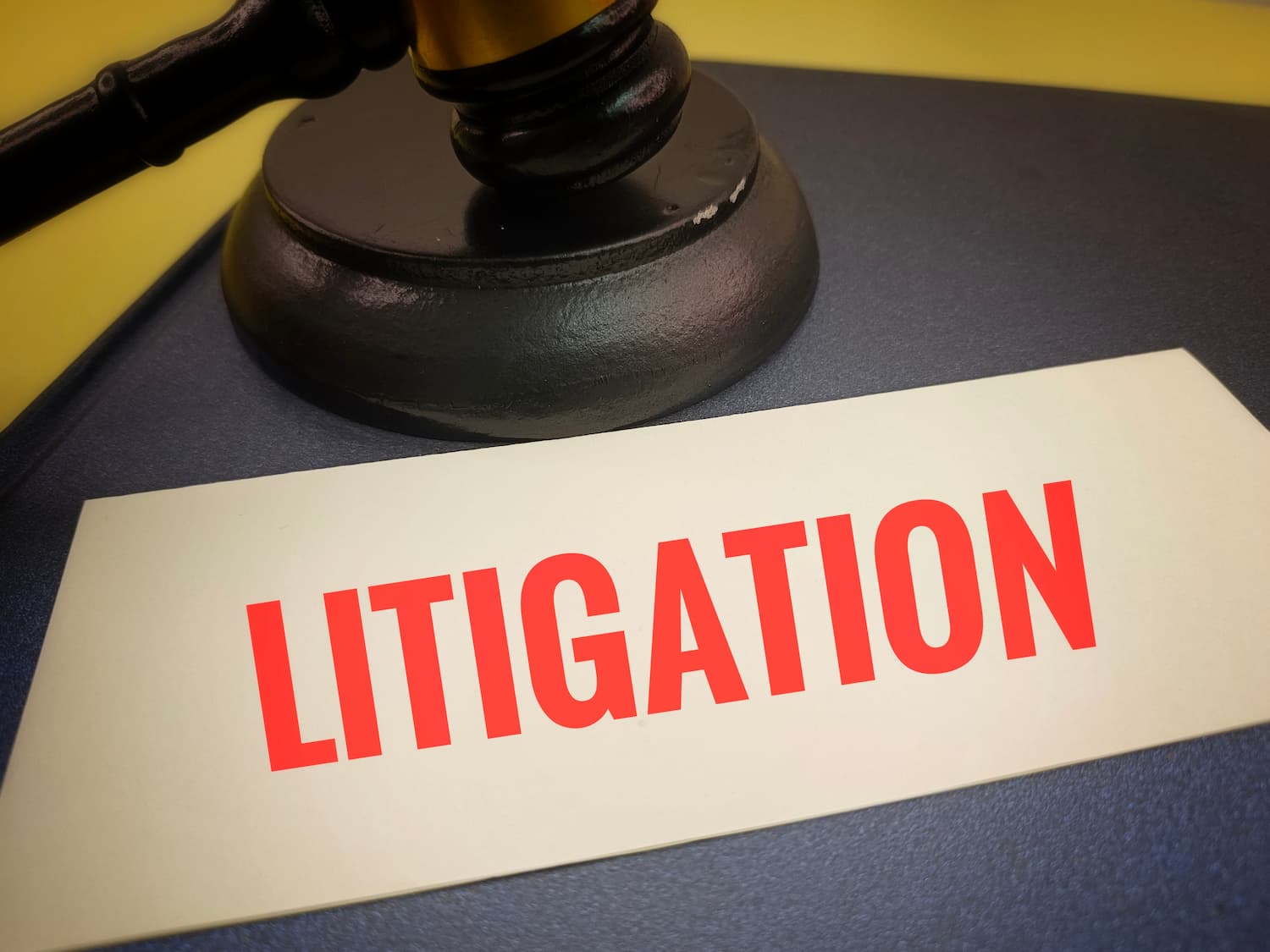 When Refusing a Settlement Offer May Lead to Litigation Litigation concept showing a judge’s gavel beside a document labeled litigation, representing a personal injury lawsuit after a rejected settlement offe