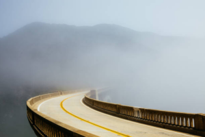Breathtaking view of a bridge with rain and fog
